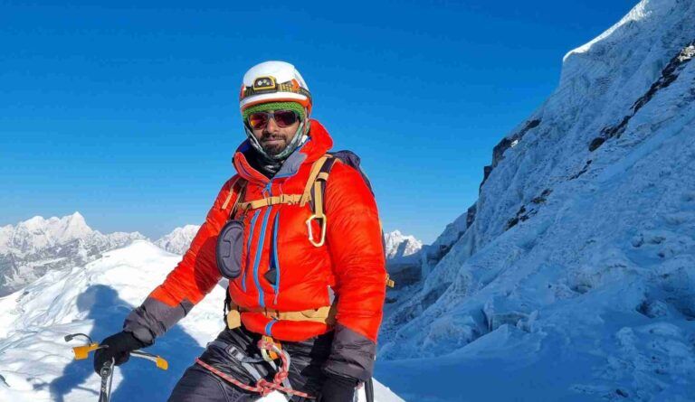 Mountaineer at the summit of Lobuche peak